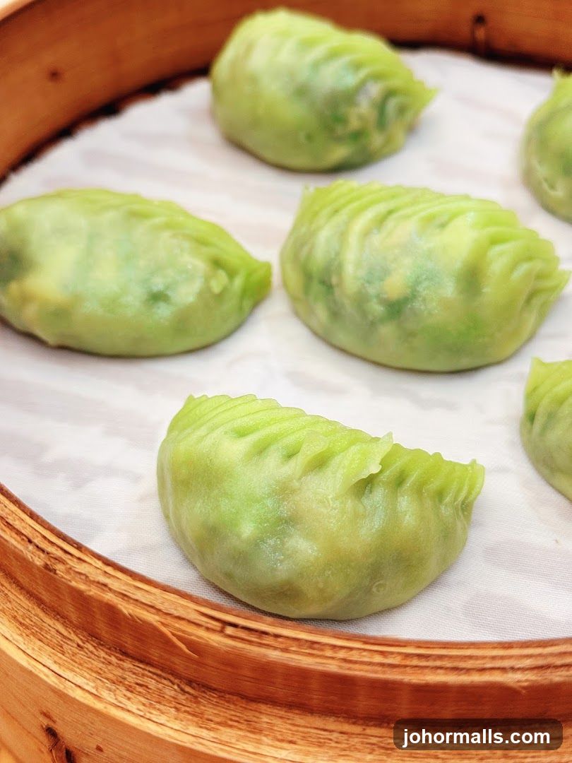 Green dumplings in bamboo steamer