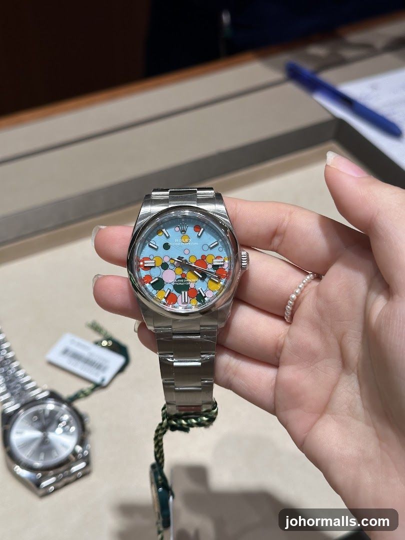 Hand holding a colorful Rolex watch