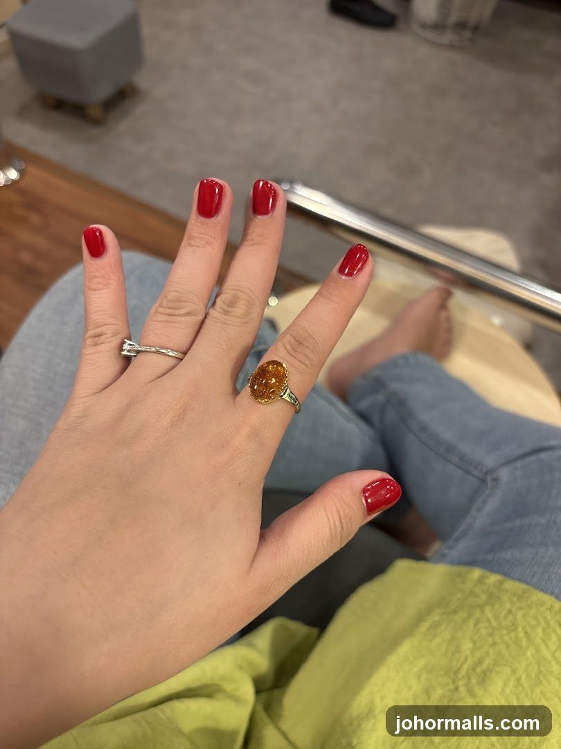 Hand with Red Nails and Rings