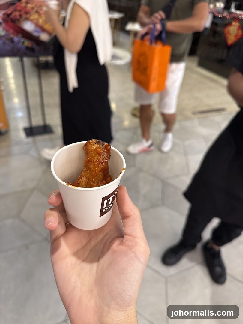 Hand holding food item in cup
