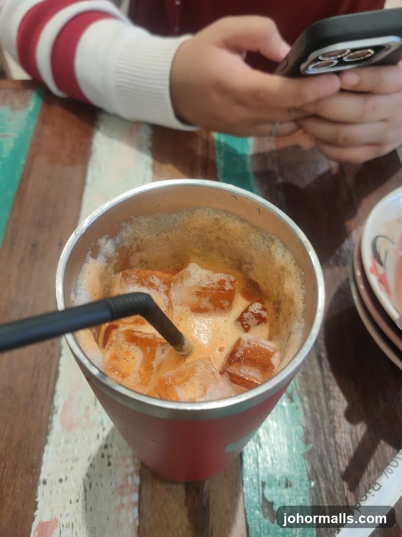 Tableside Beverage with Person Using Phone