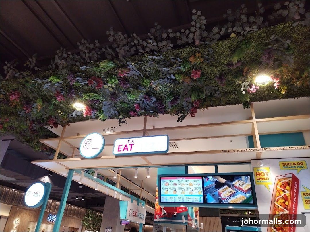 Food court stall with decorative greenery