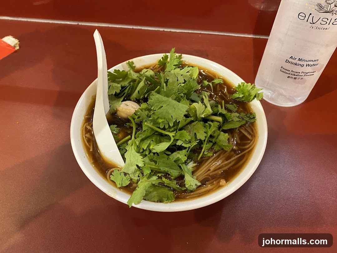 Bowl of Noodles with Cilantro and Water Bottle