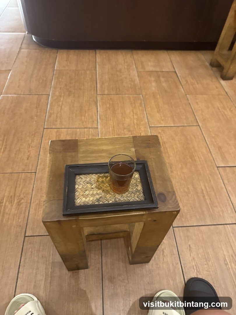 A glass of tea on a wooden stool