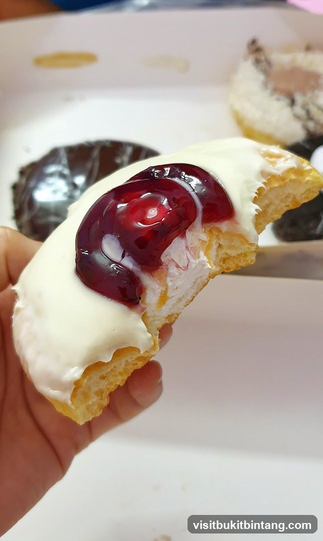 Donut with White Icing and Cherry Topping