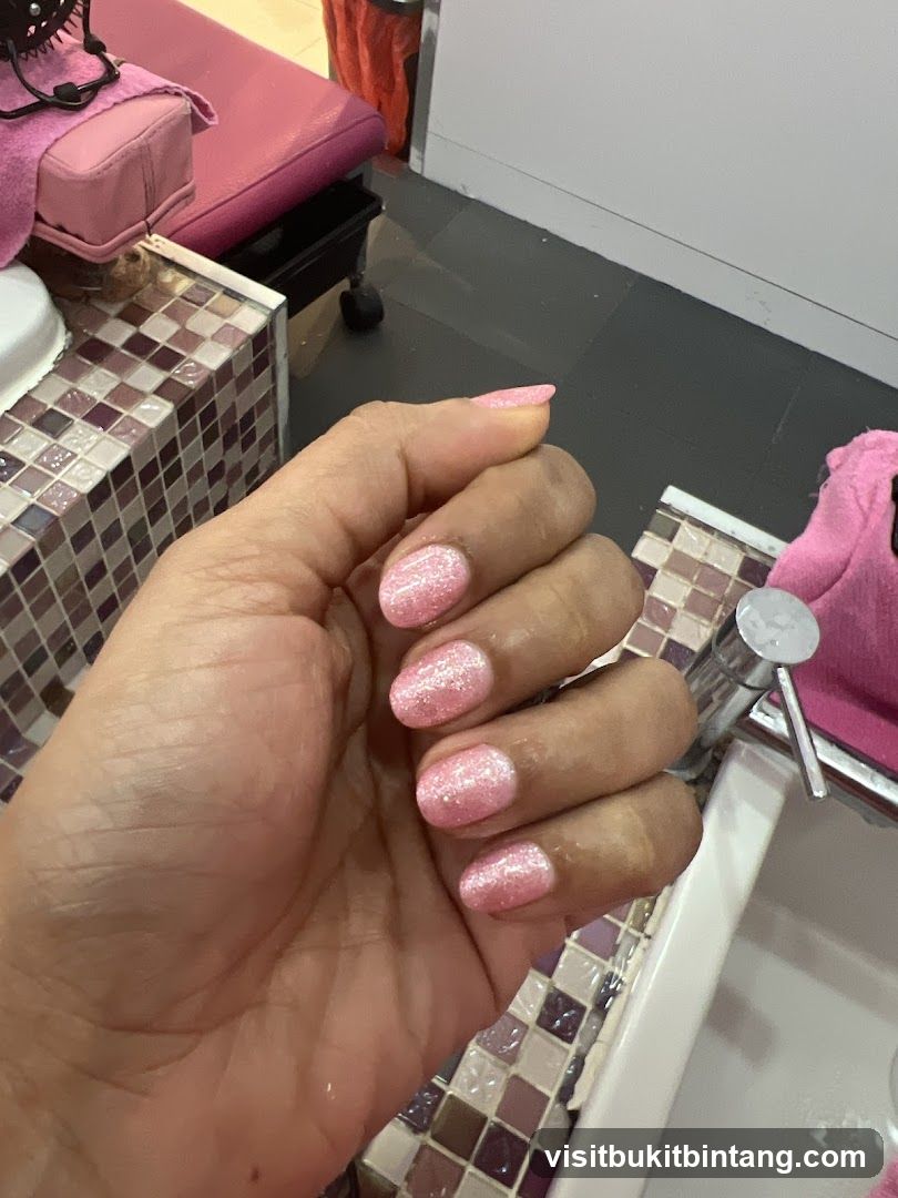 Manicured Hand with Pink Glitter Polish