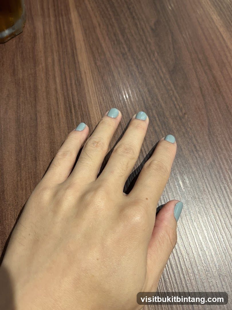 Hand with light blue nail polish