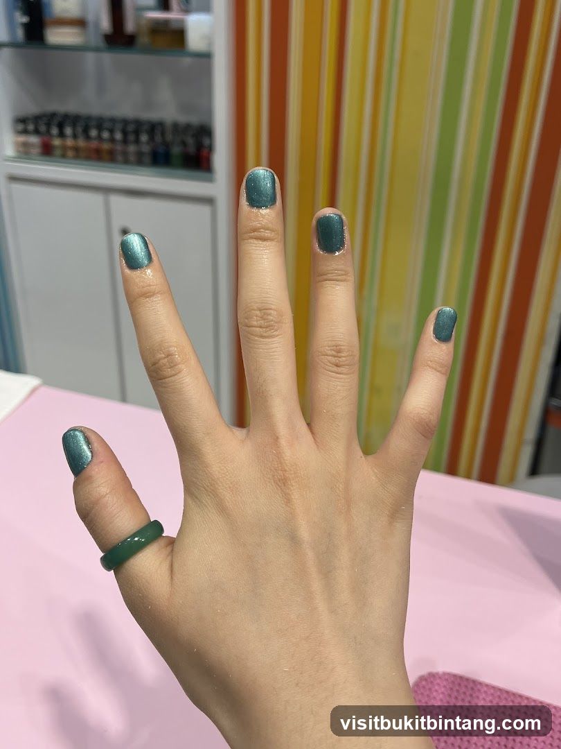 Hand with Teal Nail Polish