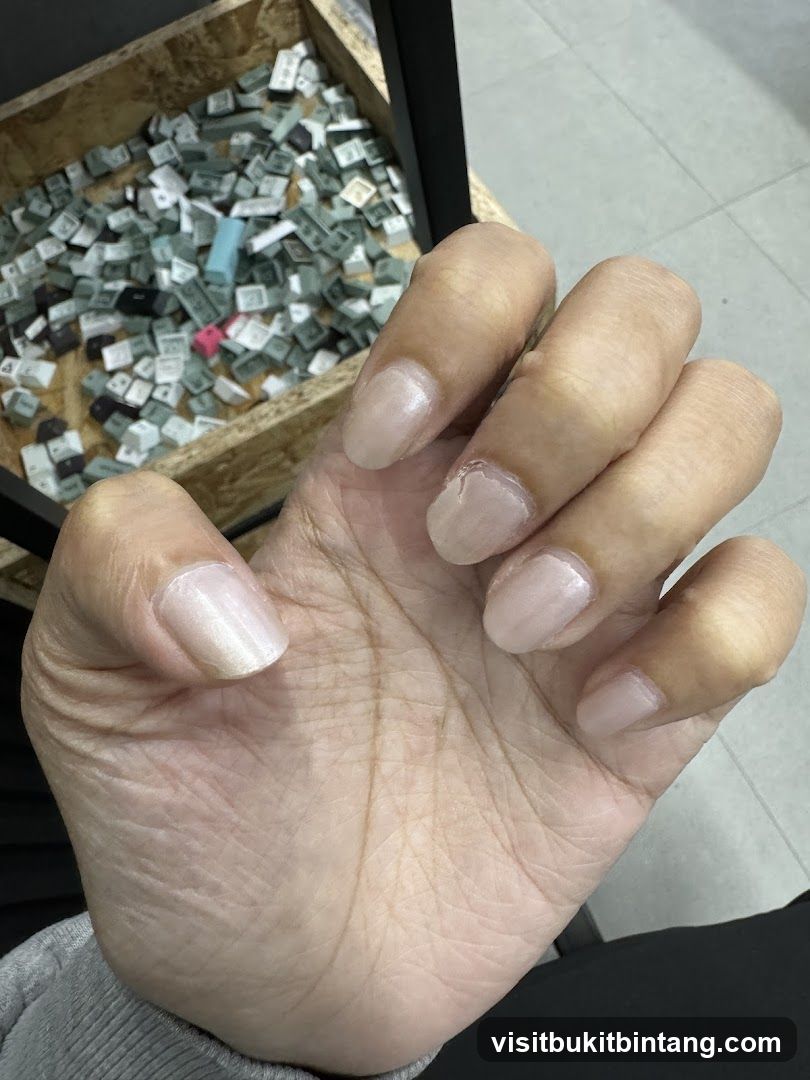 Hand with light pink nails