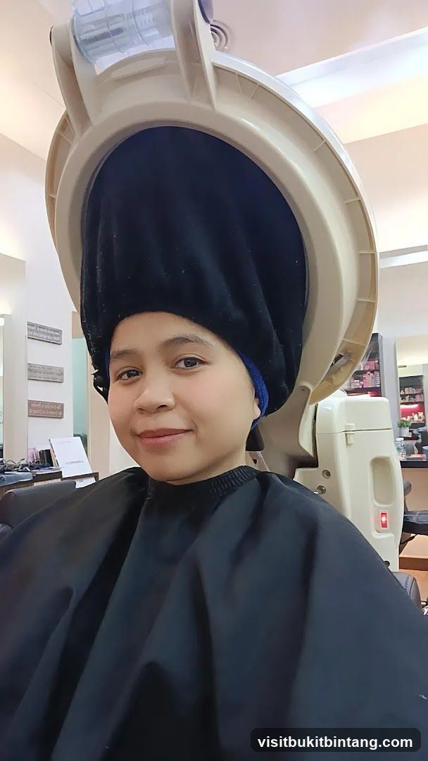 Woman under hair steamer