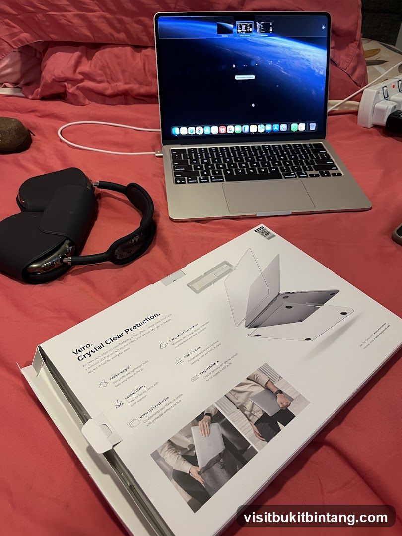 Laptop and Accessories on Bed
