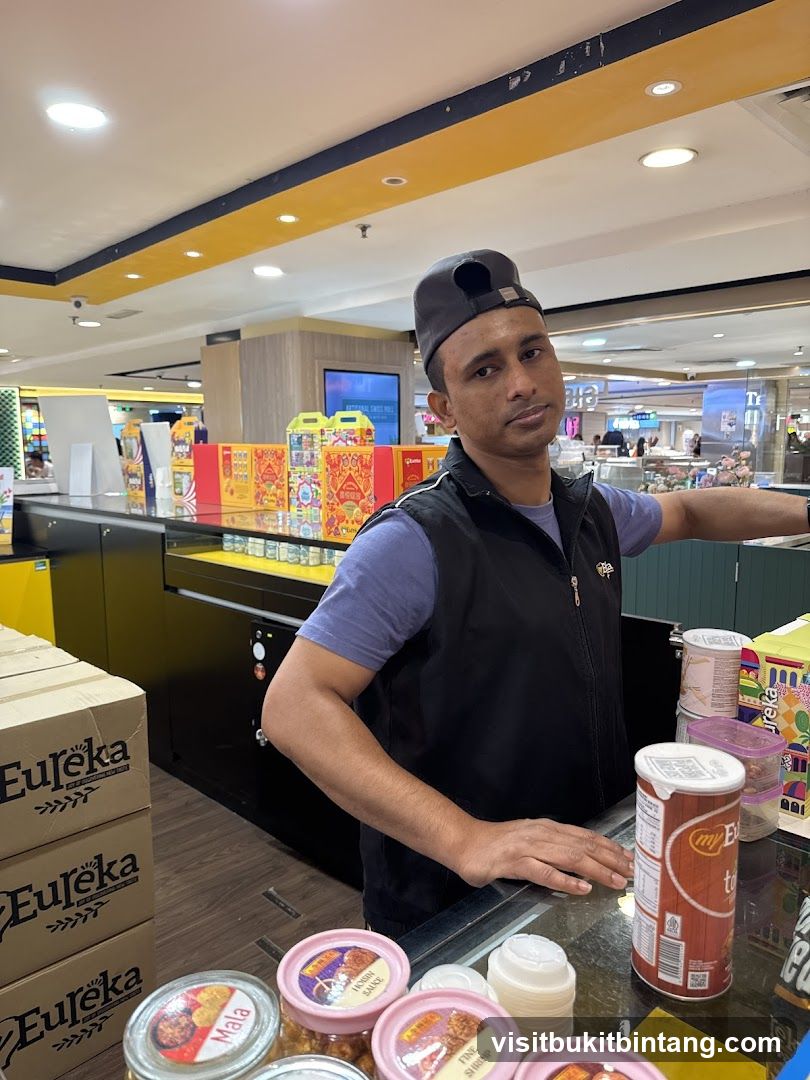 Man behind a counter with products