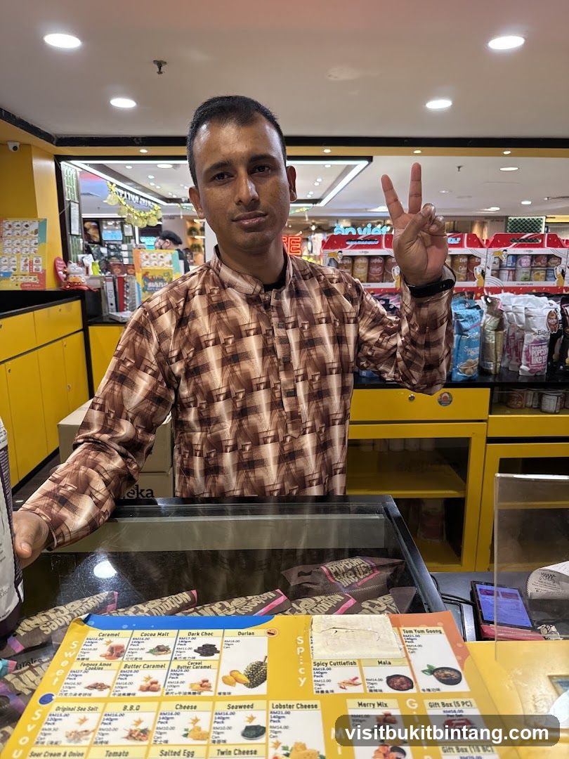 Man behind a counter with a menu