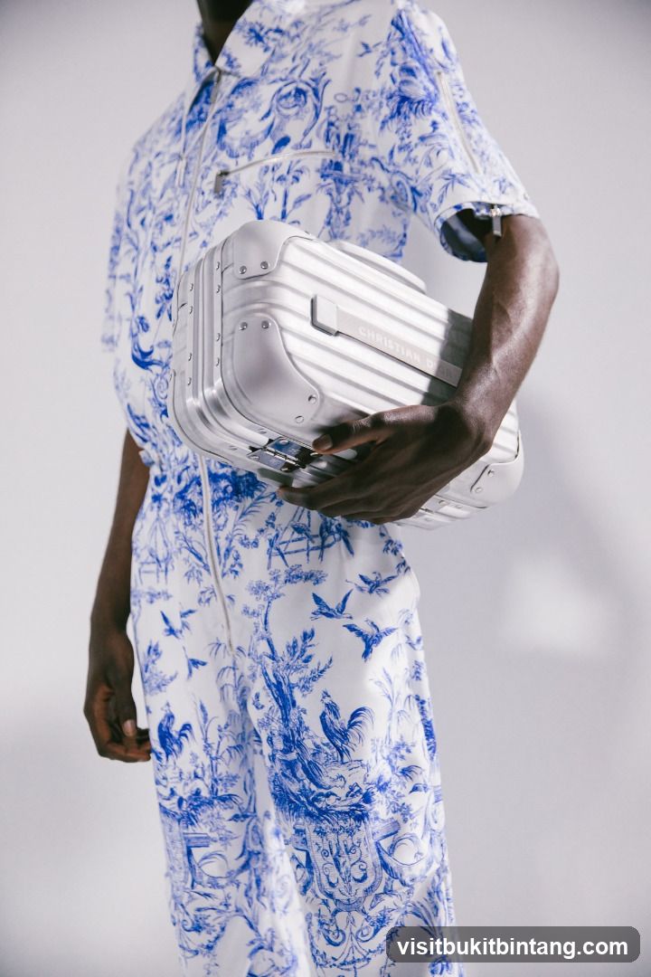 Man in Dior Jumpsuit Holding a Dior Suitcase
