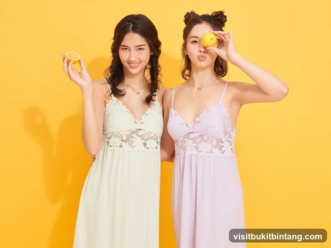 Two women in nightgowns holding lemons