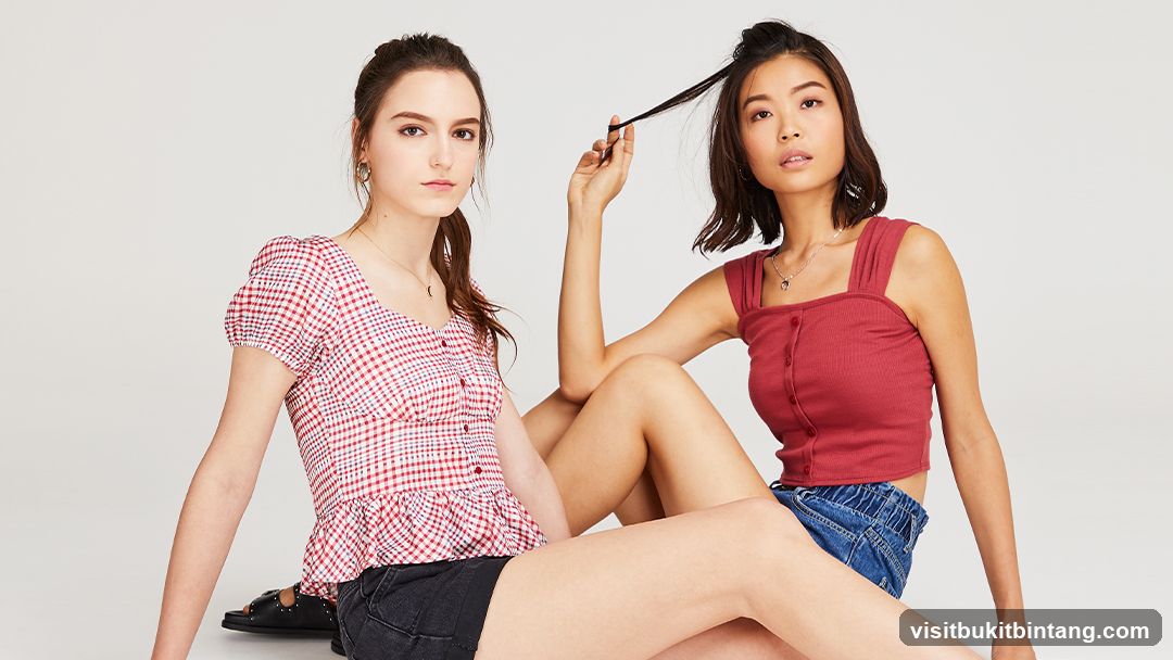 Two young women posing in casual tops