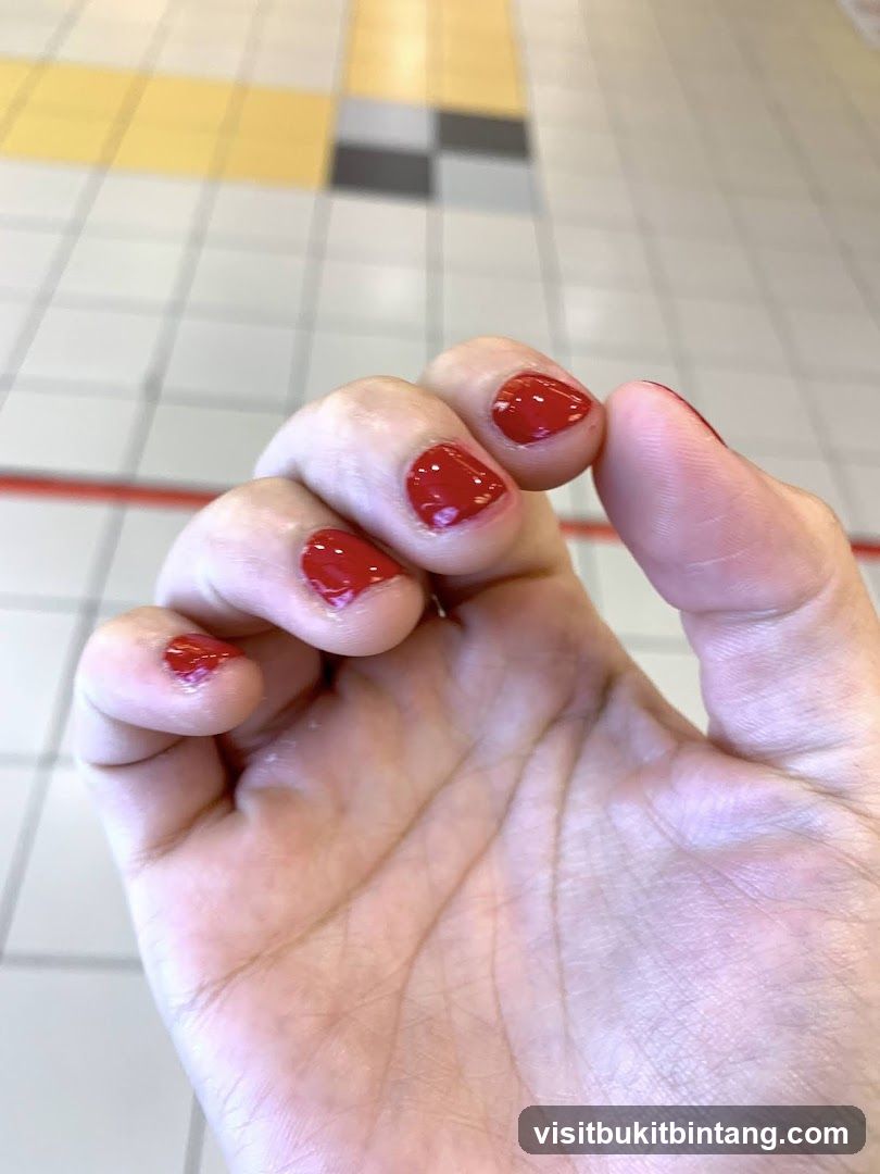 Red Nail Polish on Hand