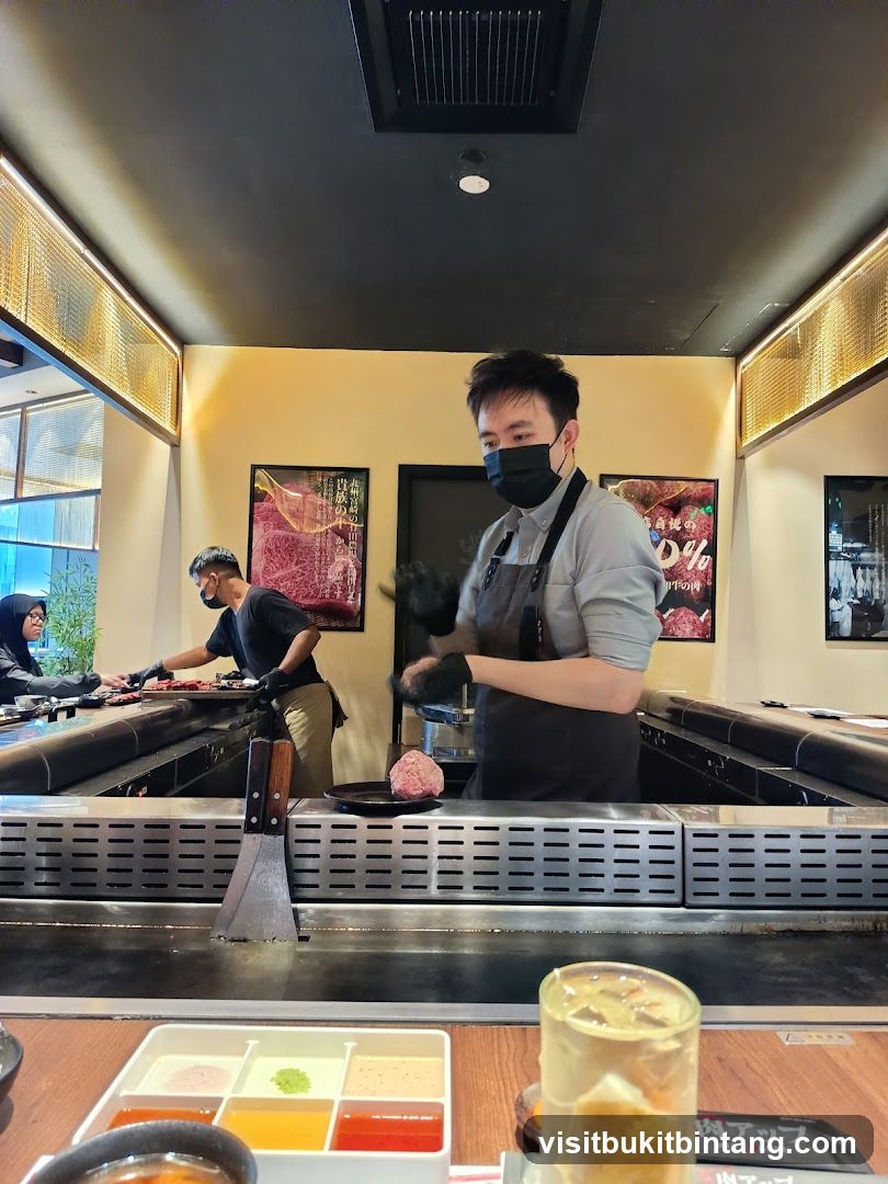 Chefs preparing food at a teppanyaki grill