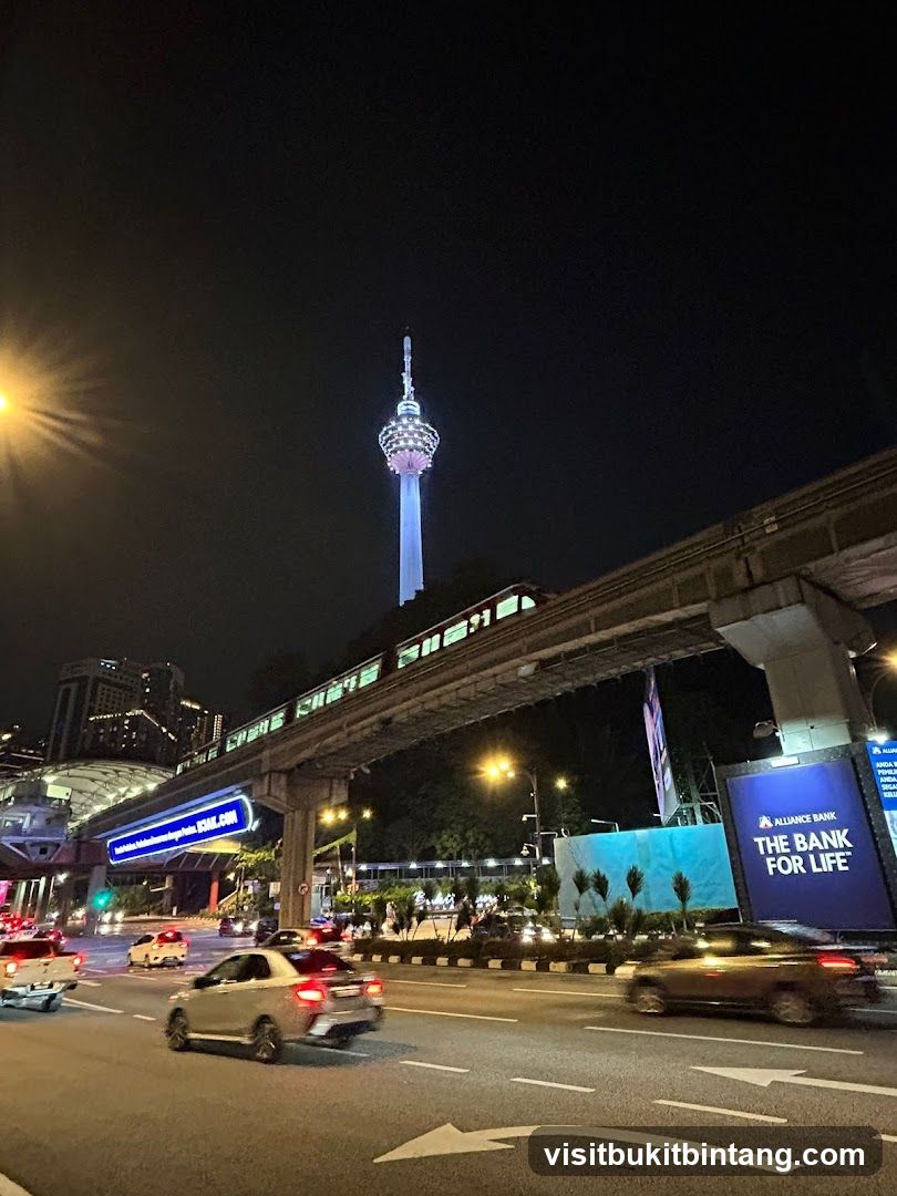 Cityscape at Night with Monorail and Tower