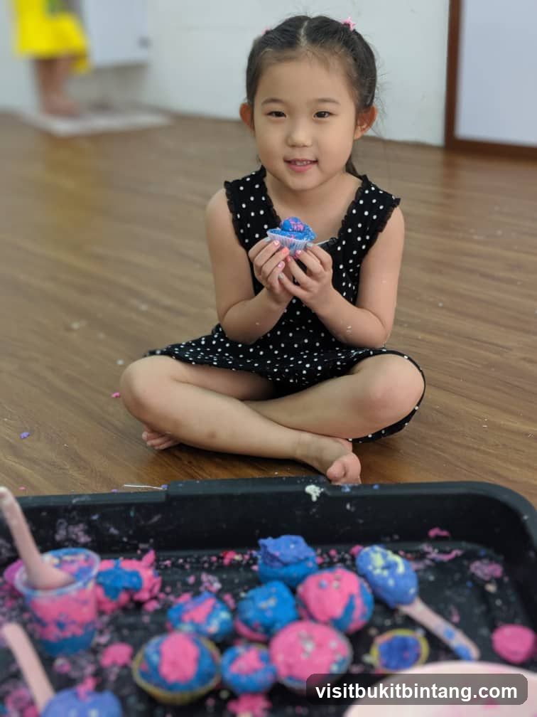 Young Girl with Cupcake and Sensory Bin