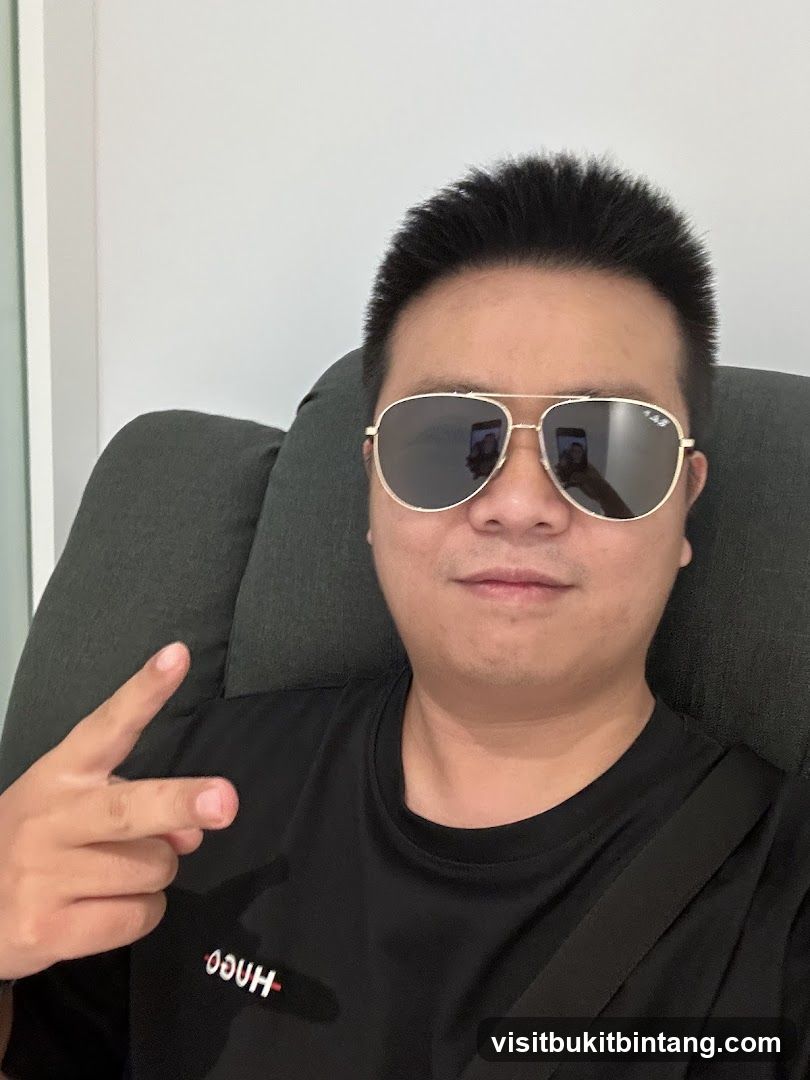 Man wearing sunglasses and a black t-shirt