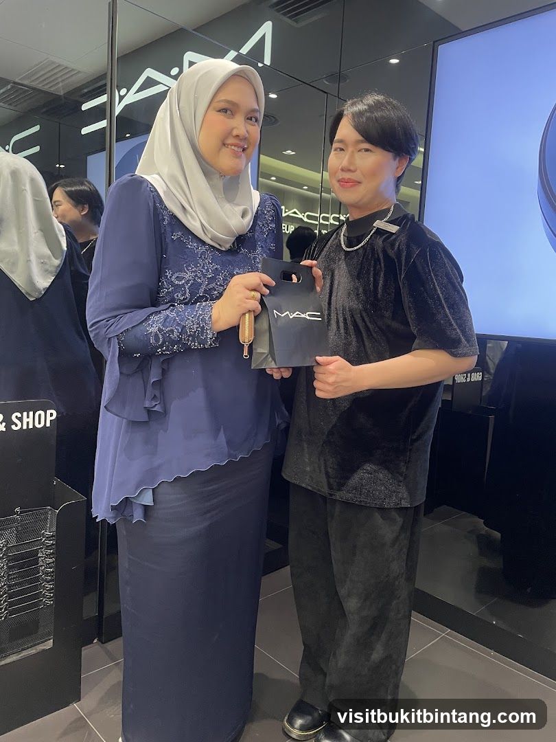 Two people posing in a MAC Cosmetics store