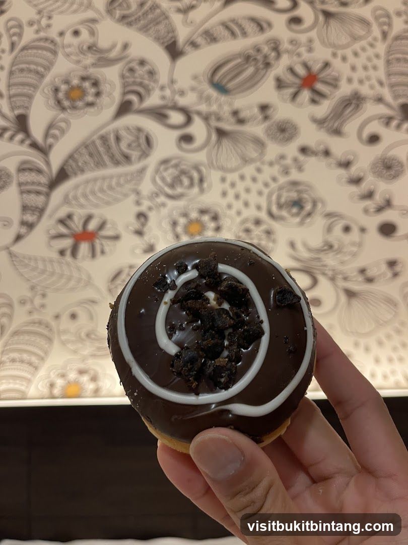 Chocolate Donut with White Swirls and Crumbs