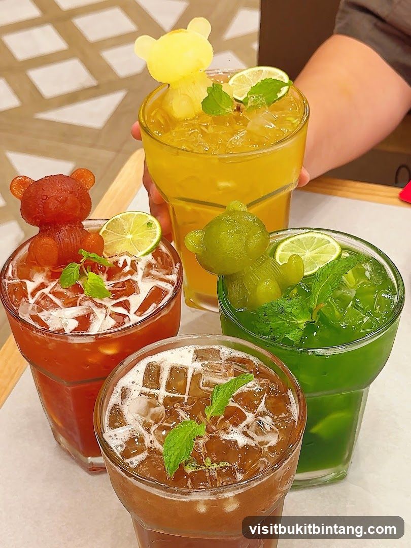 Four colorful drinks with bear-shaped ice cubes
