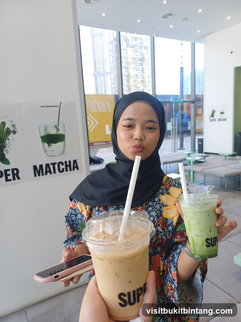 Woman holding two iced drinks