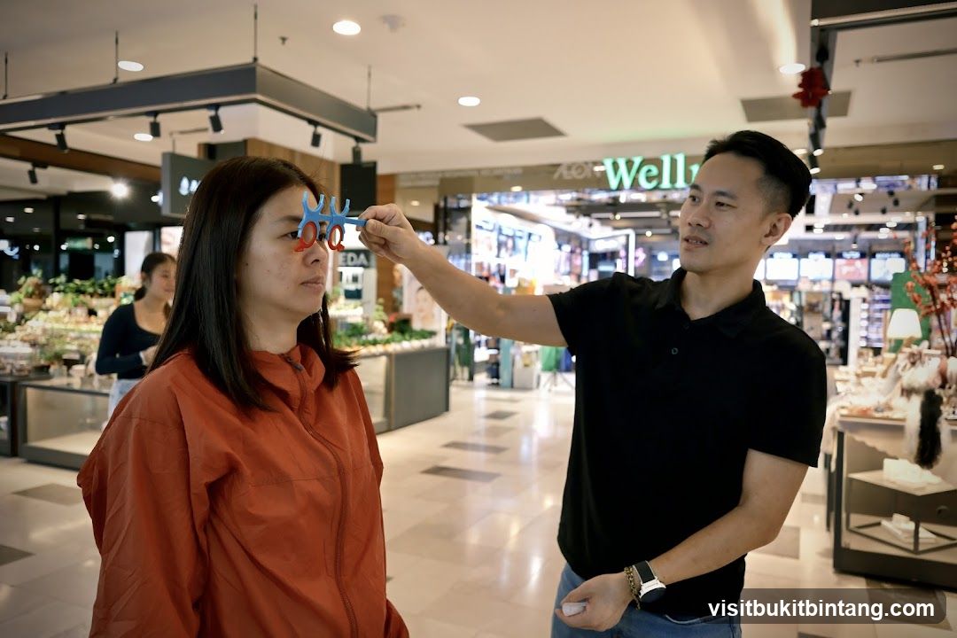 Man holding a colorful object near woman's face in mall
