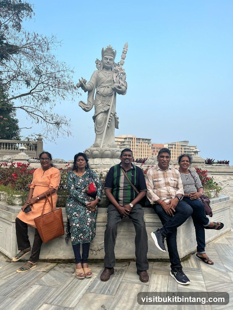 Five people posing in front of a statue