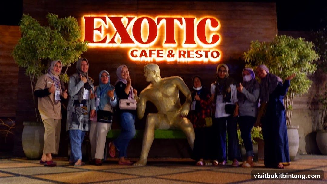 Group posing in front of Exotic Cafe & Resto sign