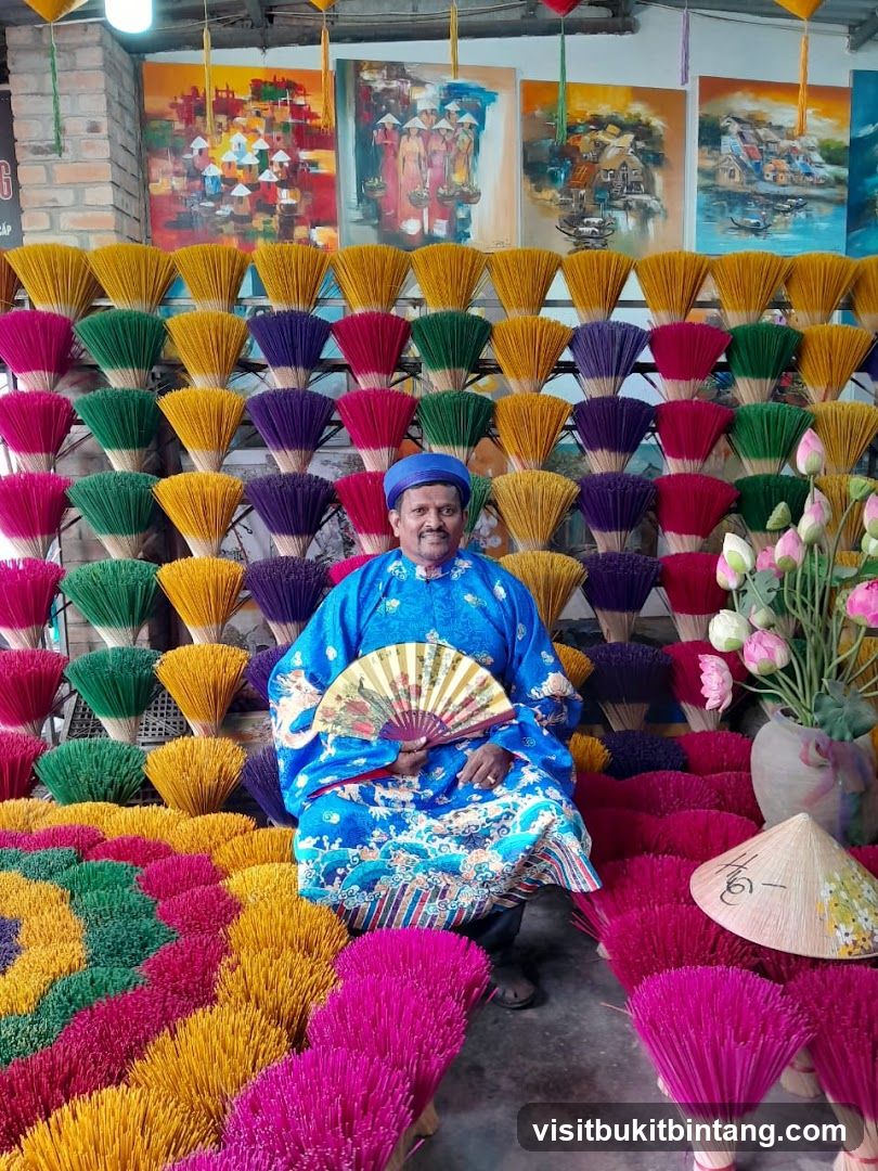 Man in traditional clothing surrounded by incense sticks