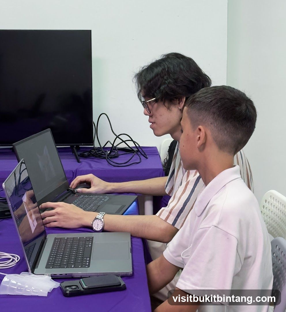 Two people working on laptops