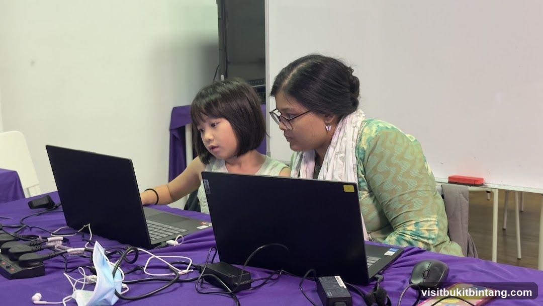 Woman and child using laptops