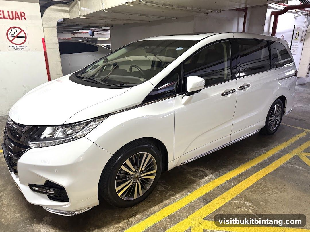 White Minivan in Parking Garage
