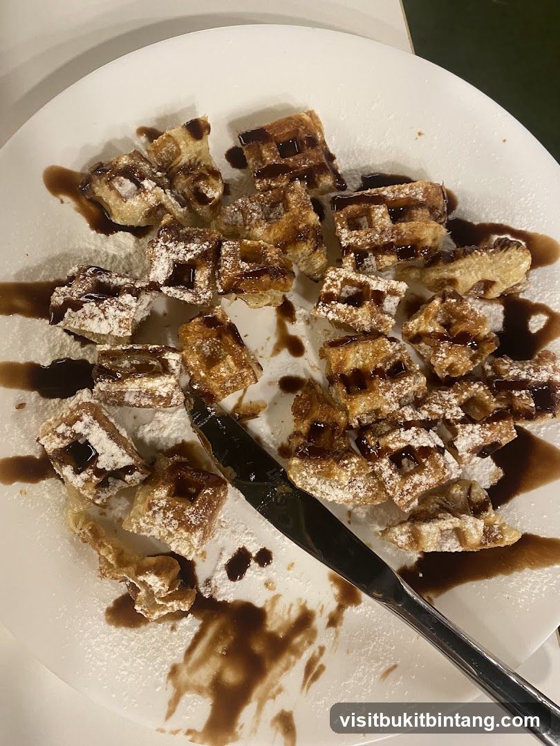 Waffles with Chocolate Sauce and Powdered Sugar