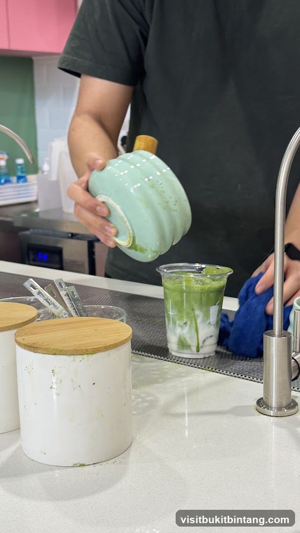 Barista preparing a matcha drink