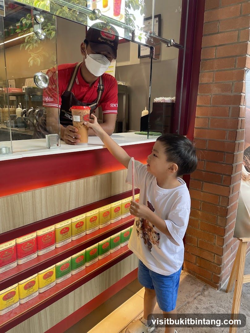 Customer receiving drink from staff