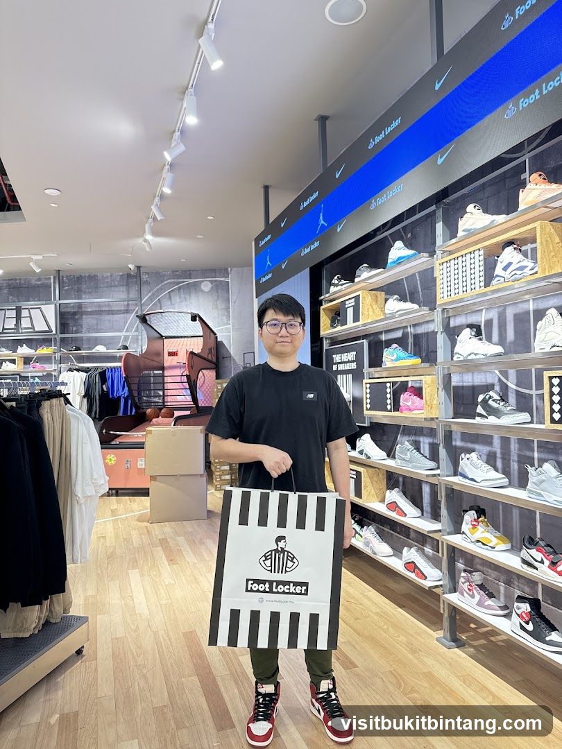 Man Holding Foot Locker Bag in Store