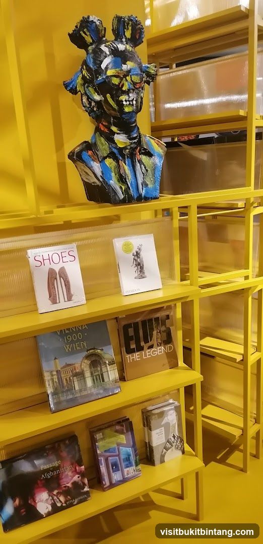 Yellow Bookshelf Display with Artistic Bust