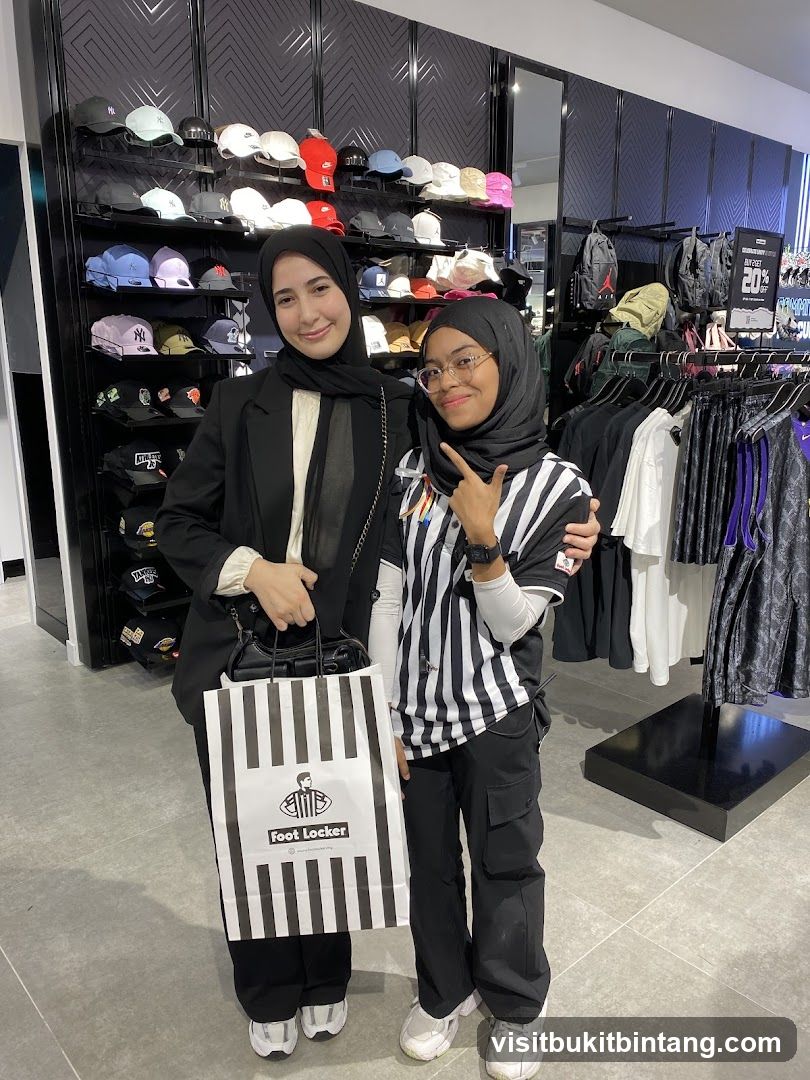 Two people posing in a Foot Locker store