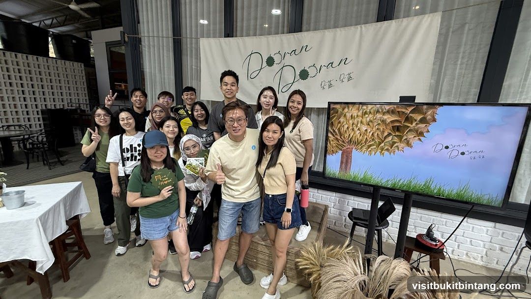 Group posing in front of a banner and screen
