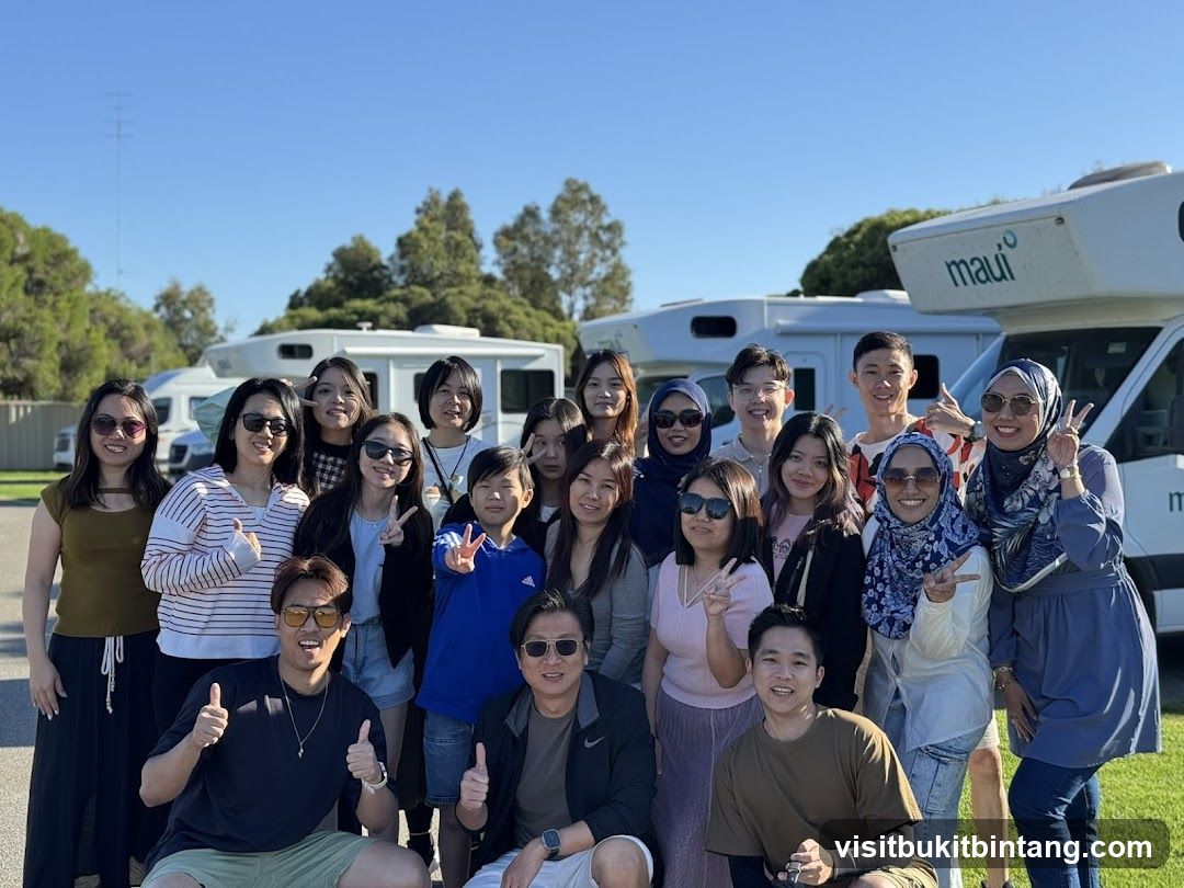 Group of people posing in front of RVs