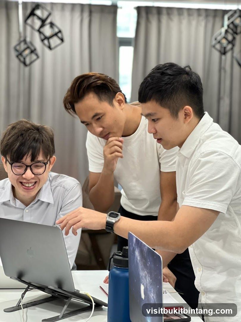 Three men looking at a laptop