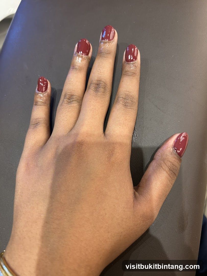 Hand with Burgundy Nails