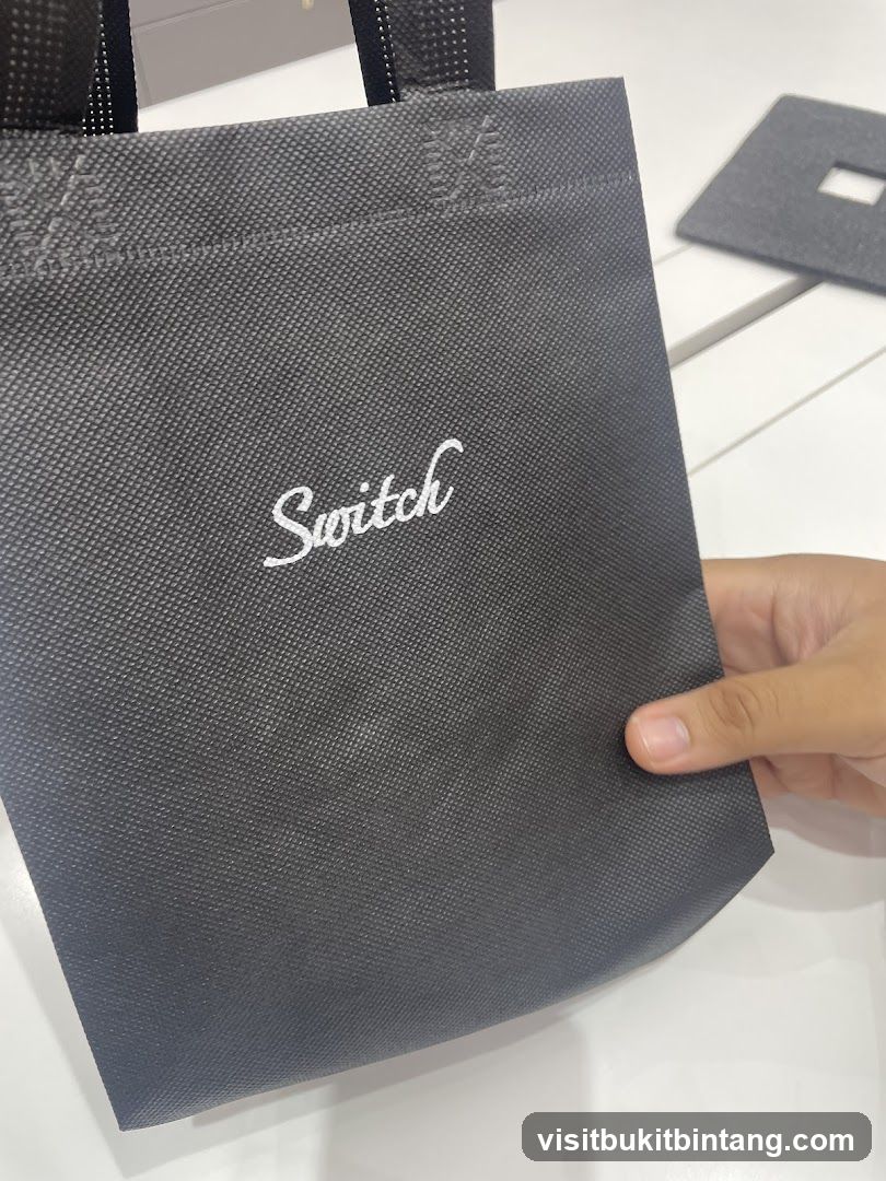 Black tote bag with "Switch" logo