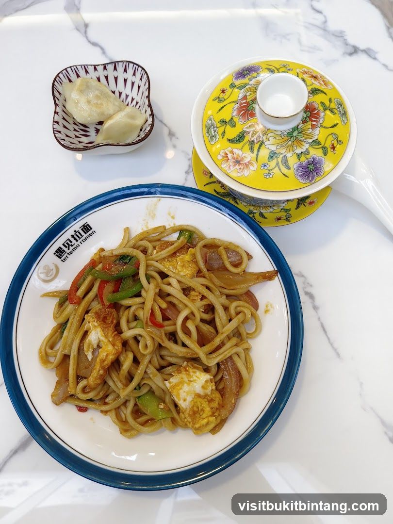 Stir-fried noodles with dumplings and tea