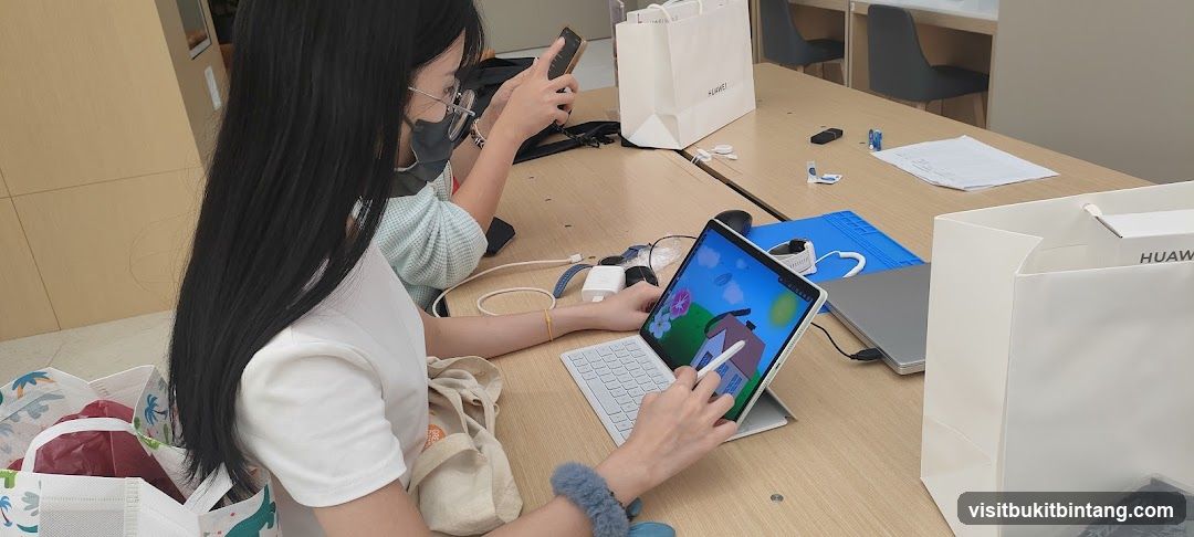 People using devices at a table