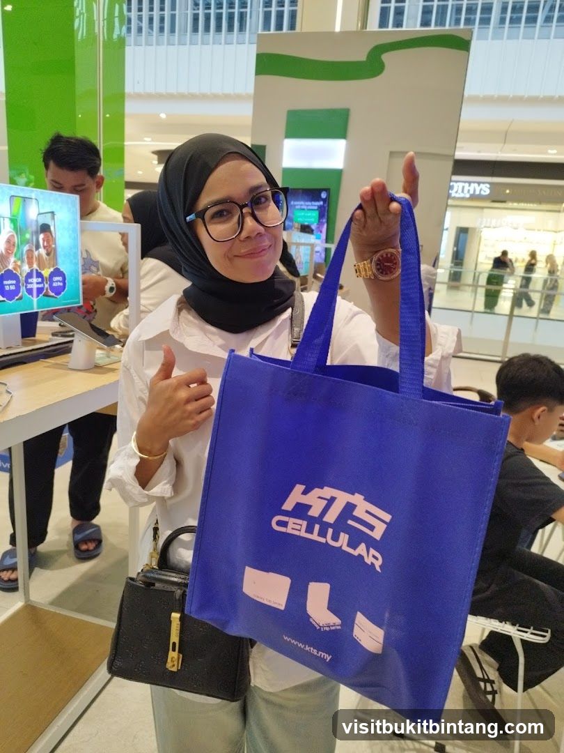 Woman holding a blue tote bag with KTS CELLULAR logo